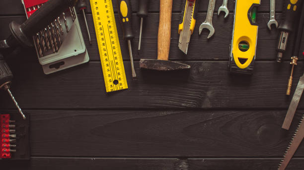 A set of tools laid out in a semicircle on top of the wooden table with copy space